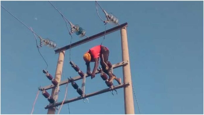 Electricity Workers On High Tension Cables In Nigeria