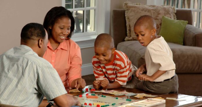 Family Playing Dice Game For Christmas