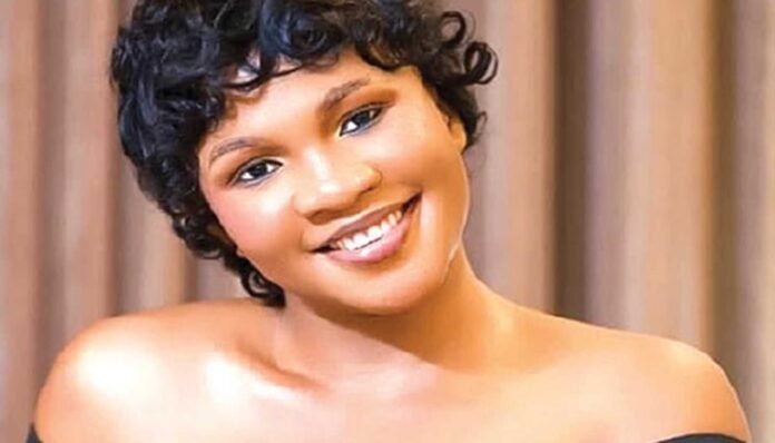 Gospel Singer Baptista With Album Cover