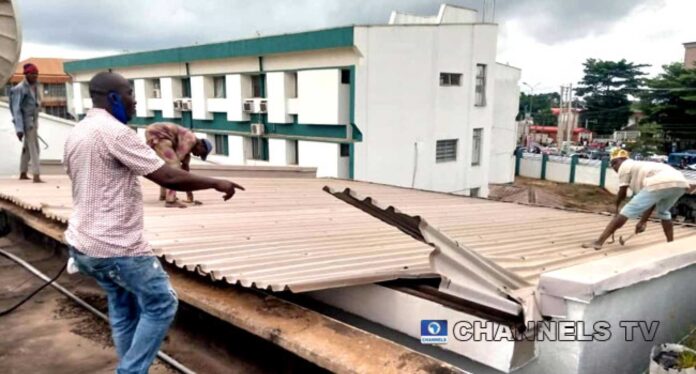 Man Removing Roof From House